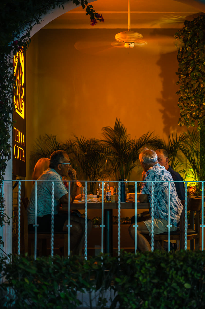Evening terrace dining under warm amber lighting